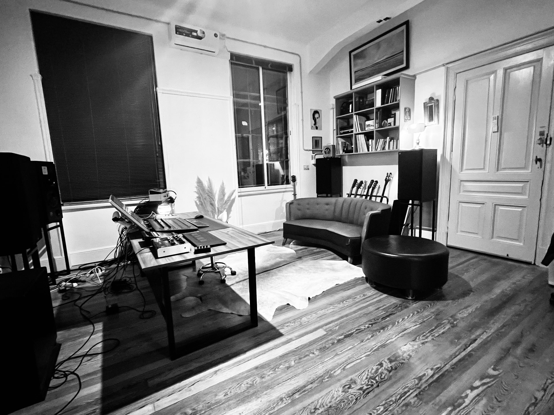 The studio room seen from the doorway: desk, monitors and seating along the walls